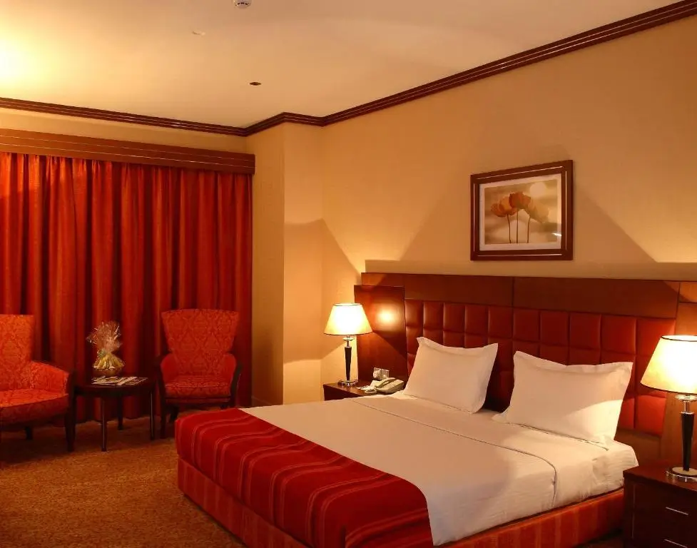 اتاق اجرایی هتل Grand Central Hotel با تخت دبل و پرده‌های قهوه‌ای